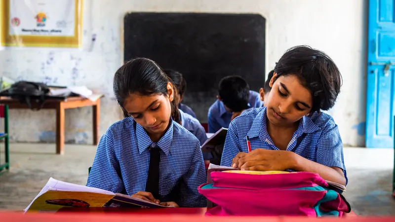 Two students concentrating on their notebooks