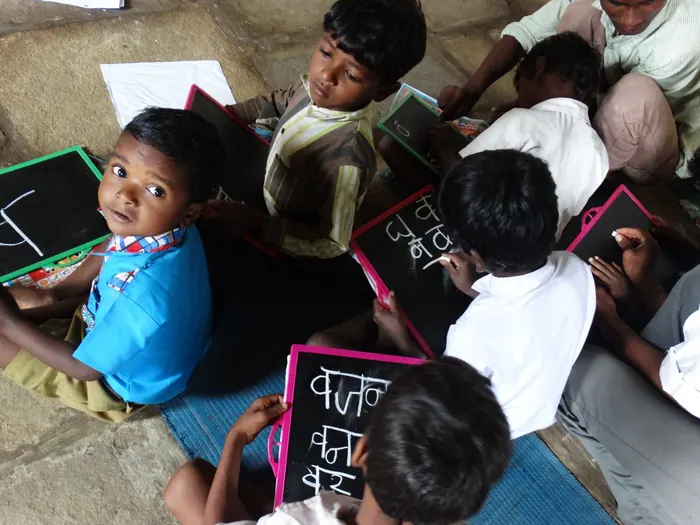 Children writing on slates, seen from above