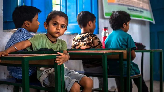 A curious student looking up in a classroom