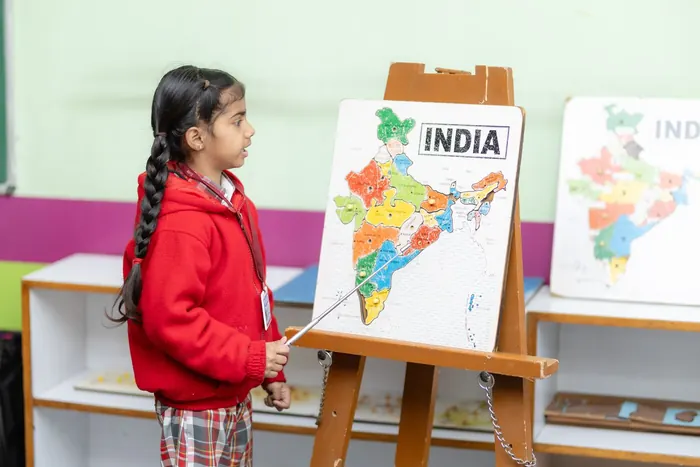 A girl presenting at a map of India