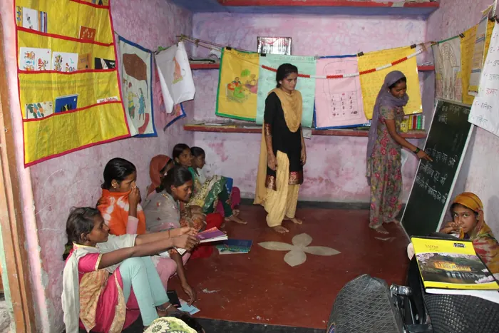 A teacher guiding students in a classroom